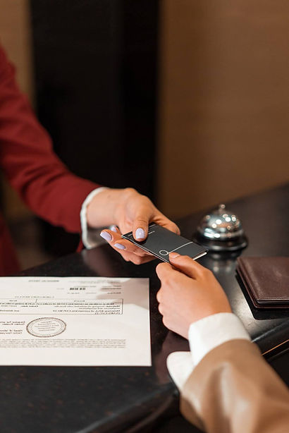 A receptionist giving a person the card to the room